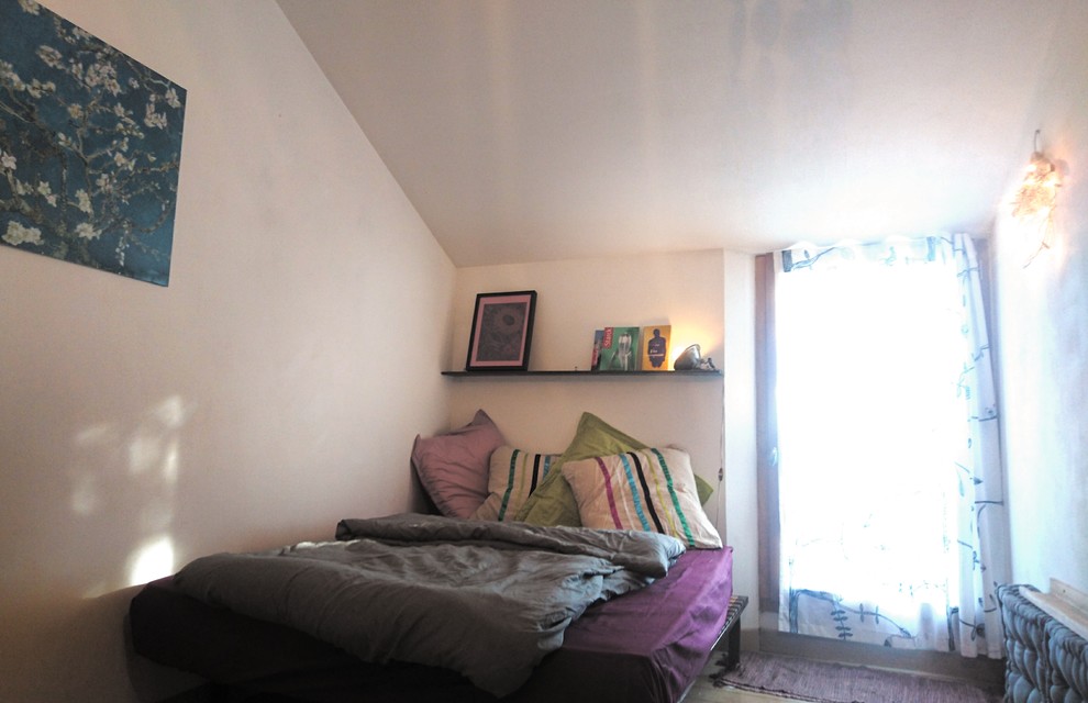 Inspiration pour une petite chambre d'amis bohème avec un mur blanc, parquet peint et un sol beige.