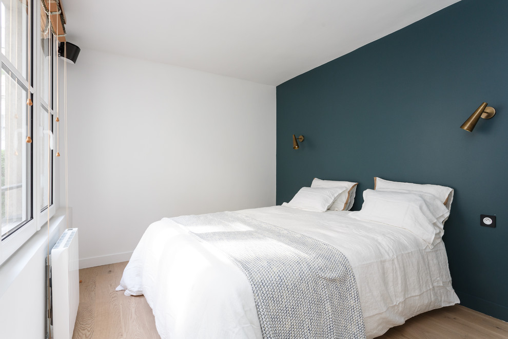 Inspiration pour une chambre parentale minimaliste de taille moyenne avec un mur bleu, parquet clair, un sol beige et aucune cheminée.