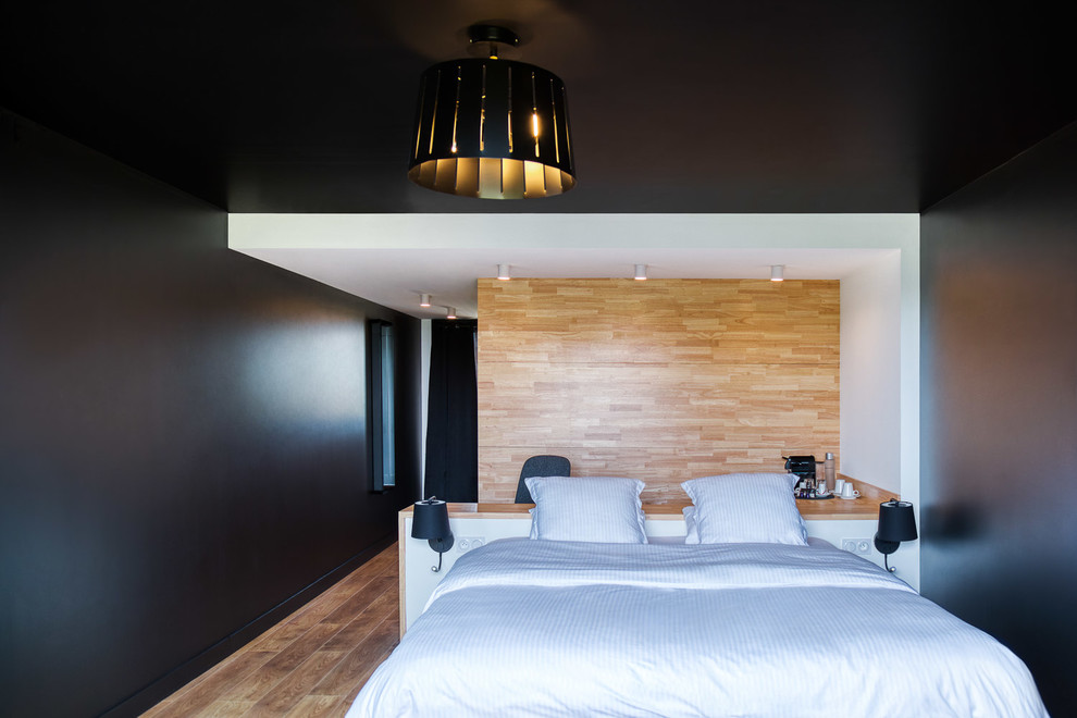 Inspiration for a large contemporary master medium tone wood floor and brown floor bedroom remodel in Toulouse with black walls