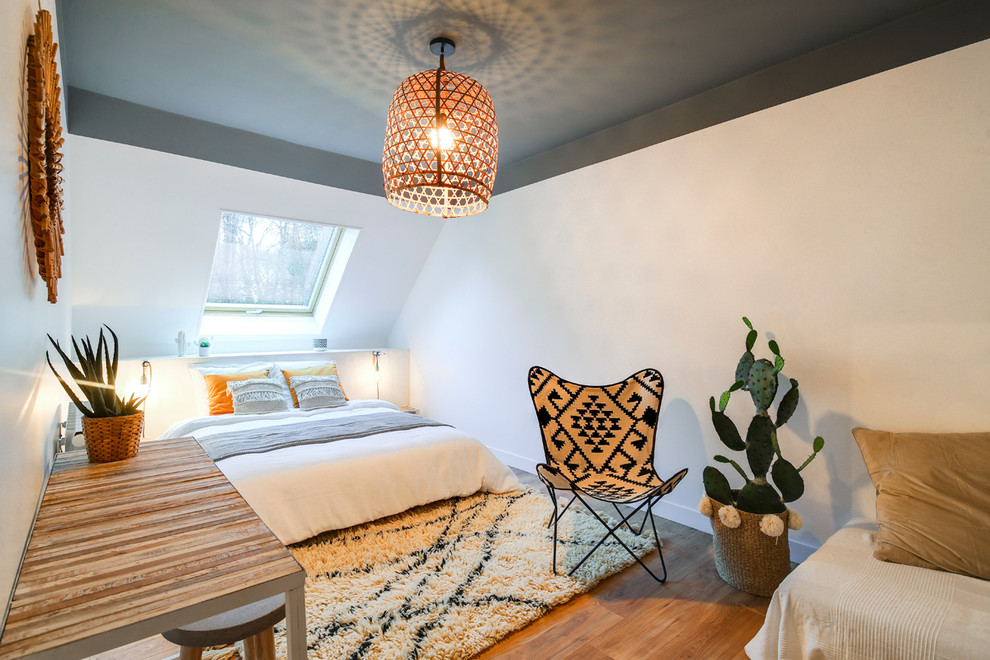 Bedroom - large contemporary medium tone wood floor and brown floor bedroom idea in Paris with white walls