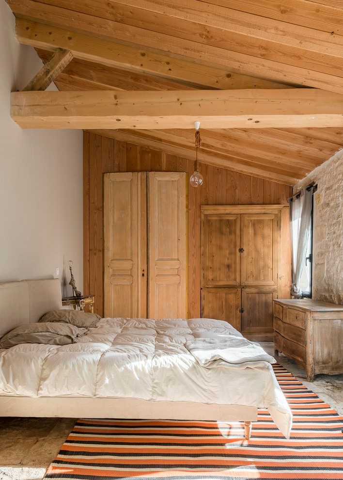 Exempel på ett medelhavsstil sovrum, med vita väggar och grått golv