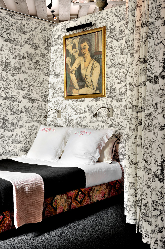 Example of an eclectic carpeted and black floor bedroom design in Paris with white walls