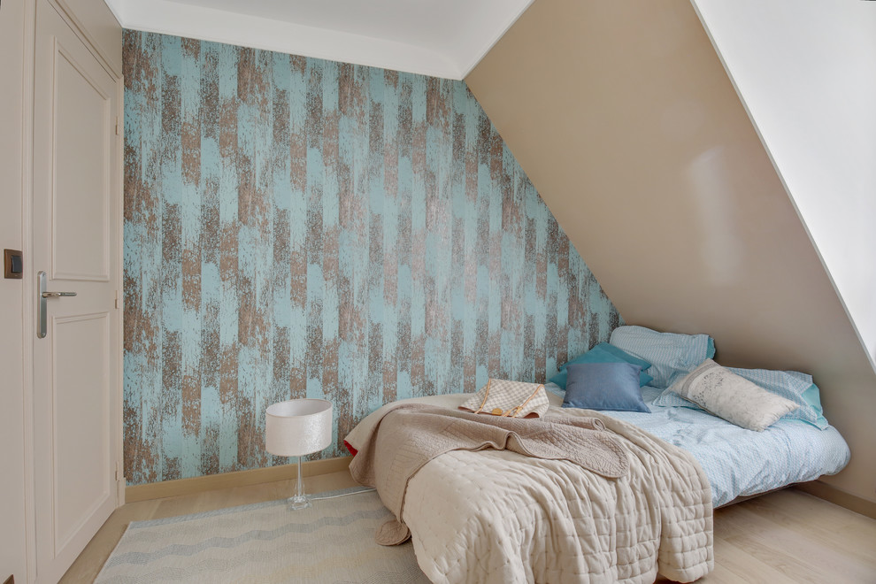 Mid-sized minimalist guest light wood floor and beige floor bedroom photo in Paris with beige walls