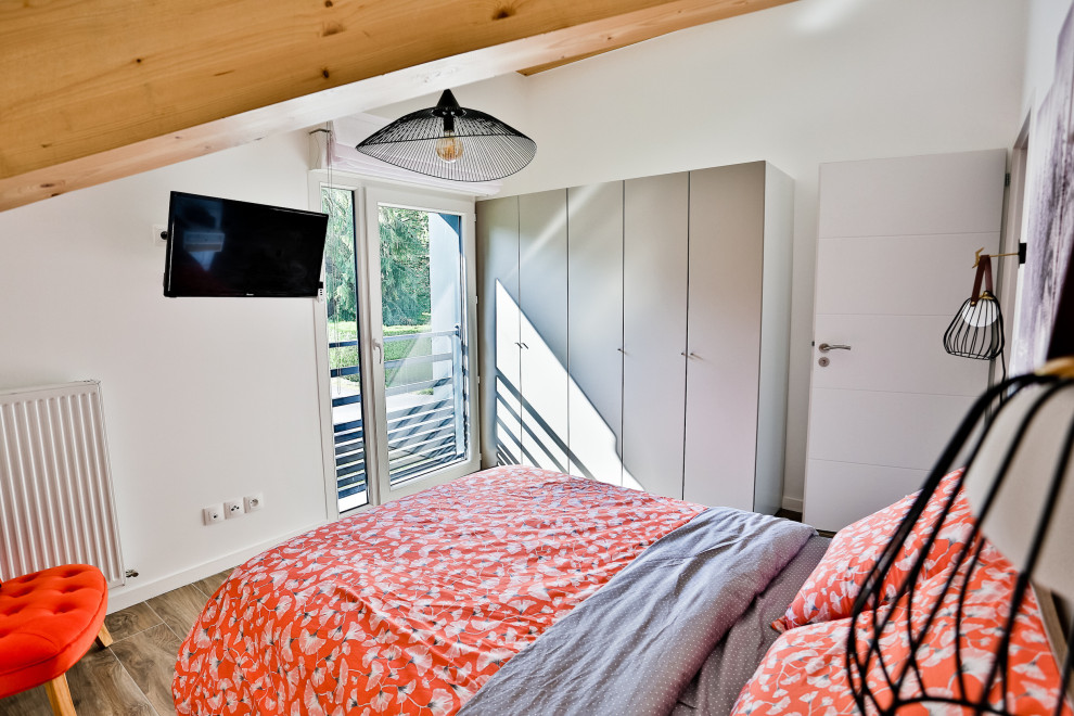 Exemple d'une grande chambre d'amis montagne avec un mur blanc, un sol en bois brun, aucune cheminée et un sol marron.