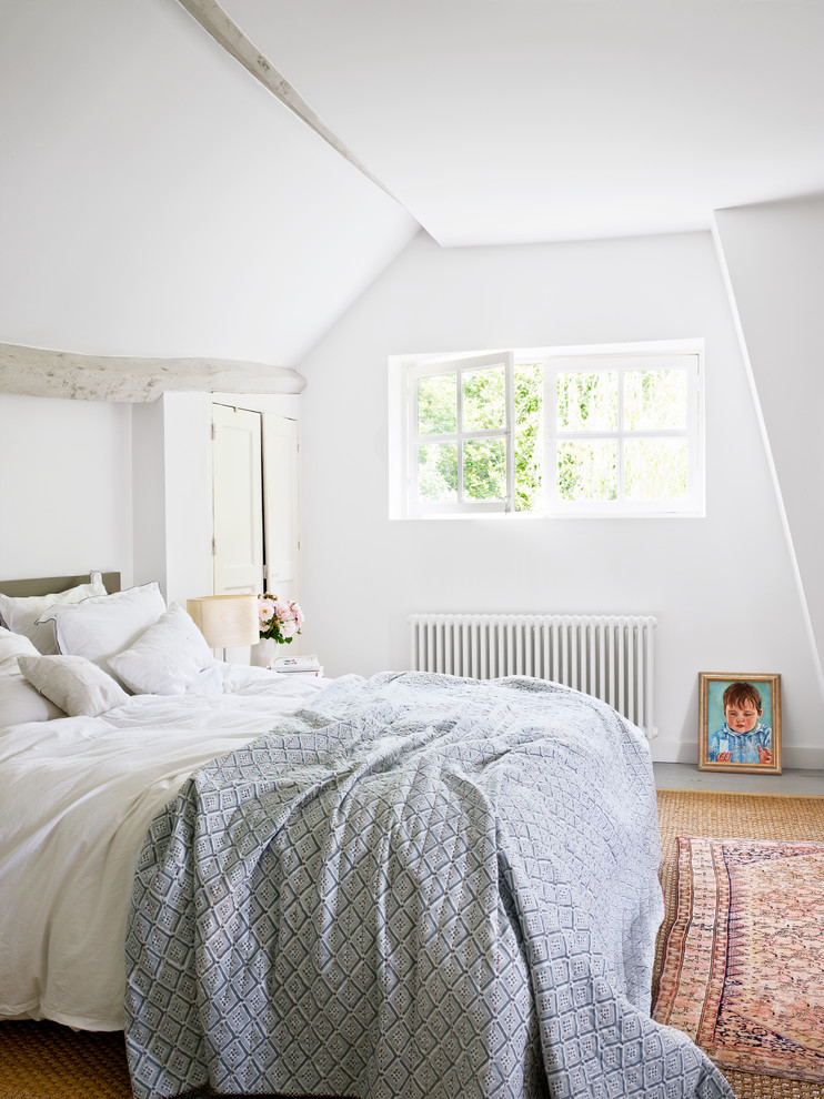 Example of a mid-sized farmhouse bedroom design in Paris with white walls
