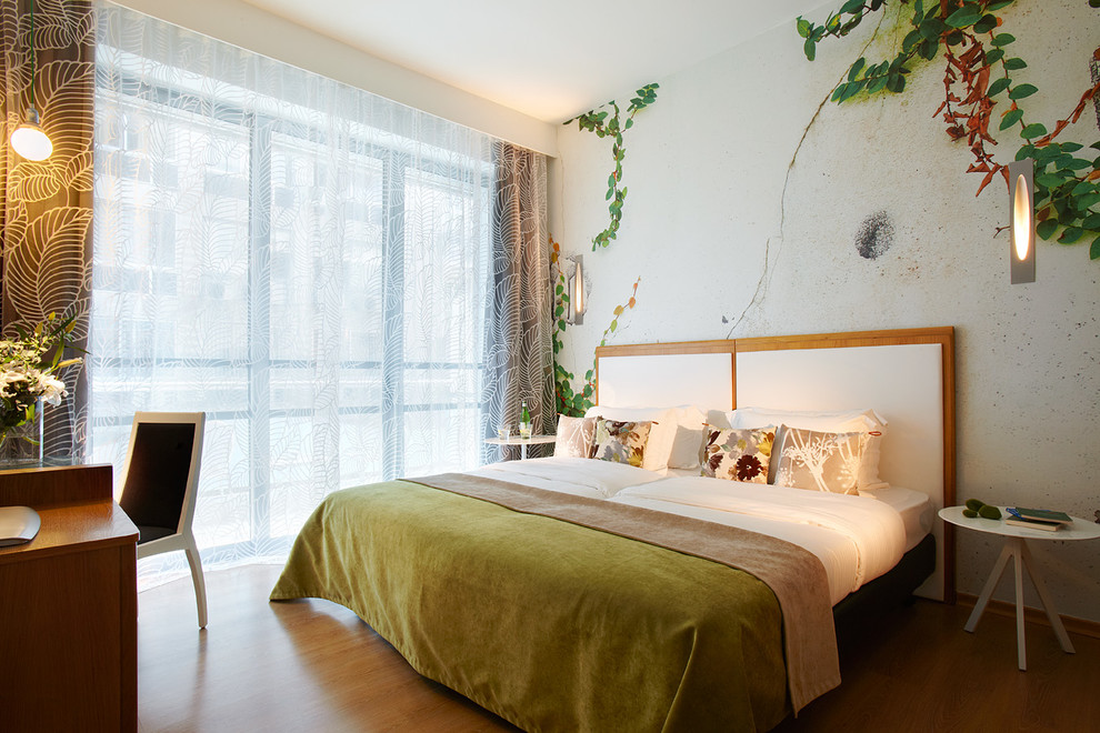 Design ideas for a medium sized contemporary master bedroom in Paris with multi-coloured walls and medium hardwood flooring.