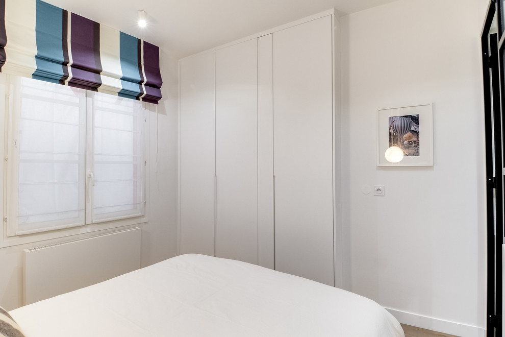 Design ideas for a medium sized scandinavian master bedroom in Paris with blue walls, dark hardwood flooring and brown floors.