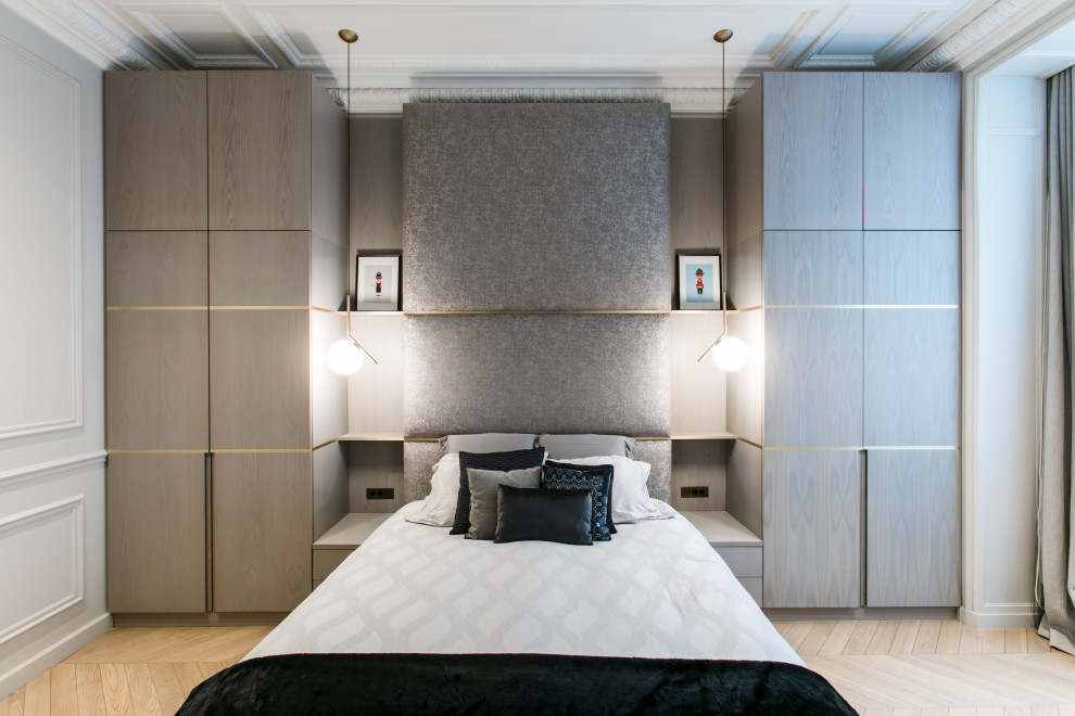 This is an example of a contemporary bedroom in Paris with light hardwood flooring and no fireplace.