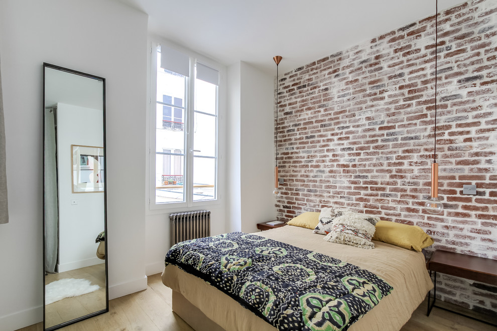 Design ideas for a medium sized industrial guest bedroom in Paris with white walls, light hardwood flooring and no fireplace.