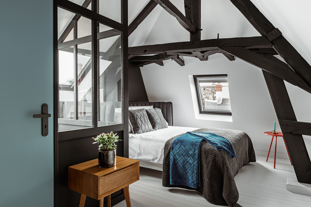 Immagine di un'In mansarda camera da letto scandinava con pareti bianche, pavimento in legno verniciato, nessun camino e pavimento bianco