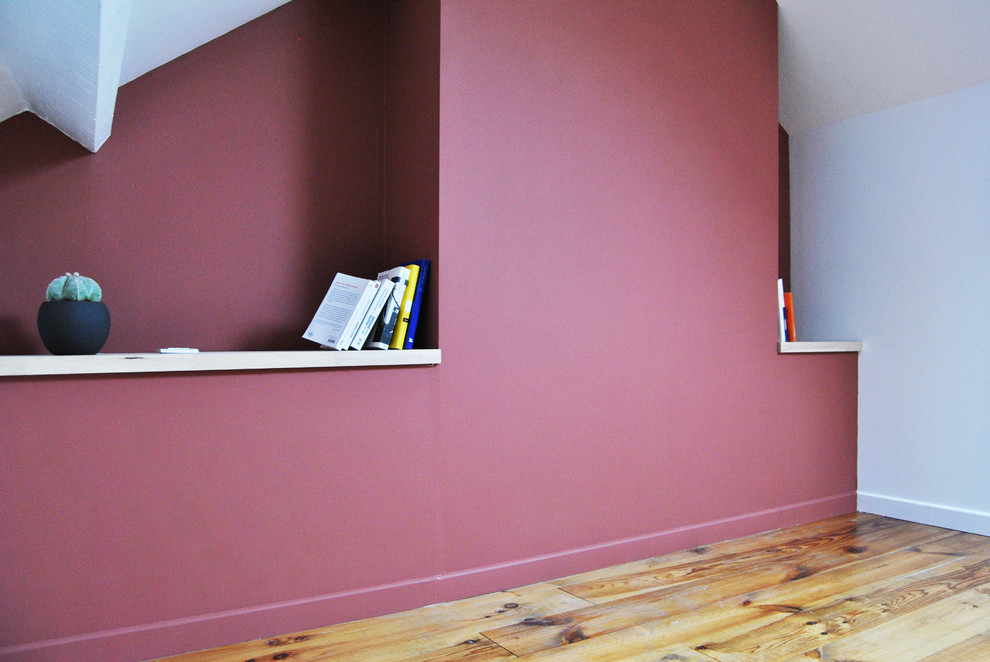 Imagen de dormitorio principal actual de tamaño medio sin chimenea con paredes rojas y suelo de madera en tonos medios