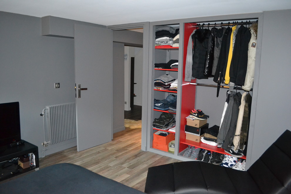 Example of a mid-sized trendy master laminate floor and gray floor bedroom design in Paris with gray walls