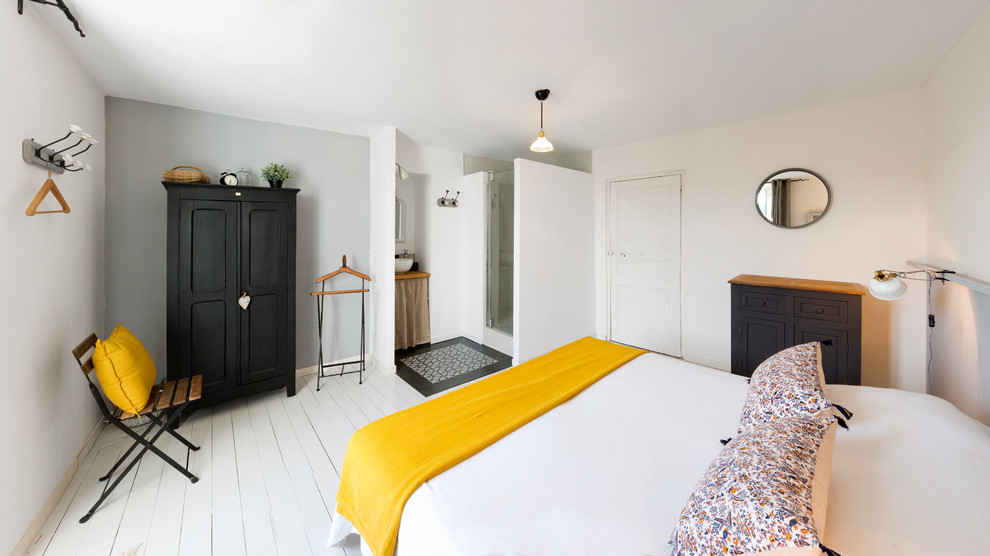 Example of a mid-sized danish master painted wood floor bedroom design in Nantes with white walls and no fireplace