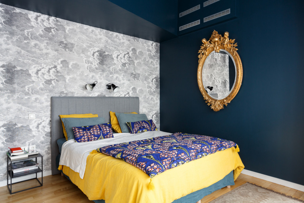 Aménagement d'une chambre parentale éclectique de taille moyenne avec un mur bleu, parquet clair, aucune cheminée et un sol beige.