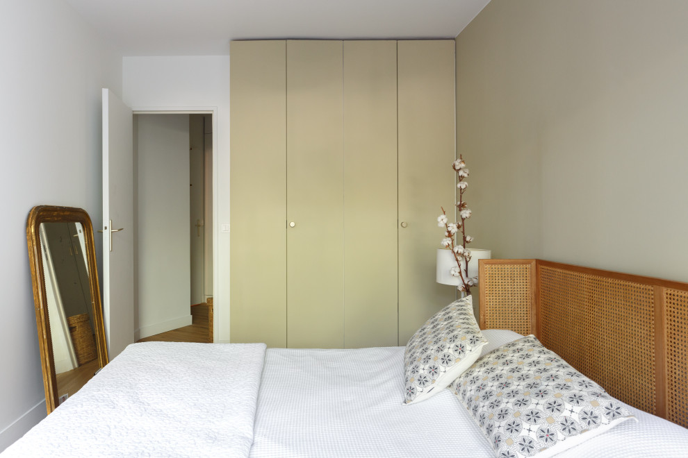 Modelo de dormitorio principal nórdico de tamaño medio con paredes beige, suelo de madera clara y suelo beige