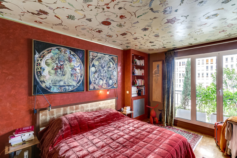Medium sized bohemian master bedroom in Paris with red walls, light hardwood flooring and no fireplace.