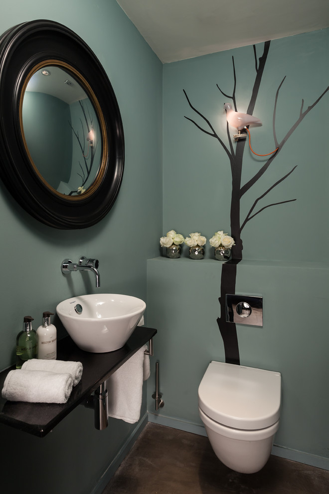 Trendy powder room photo in Other with a vessel sink and blue walls