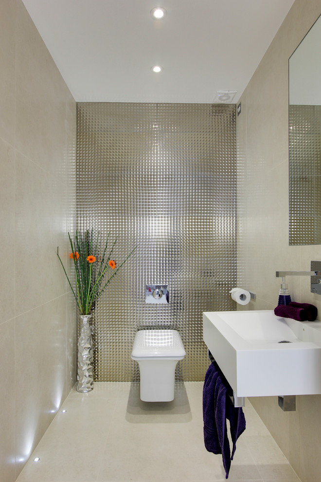 Example of a small trendy metal tile porcelain tile powder room design in Hertfordshire with a wall-mount sink and a wall-mount toilet