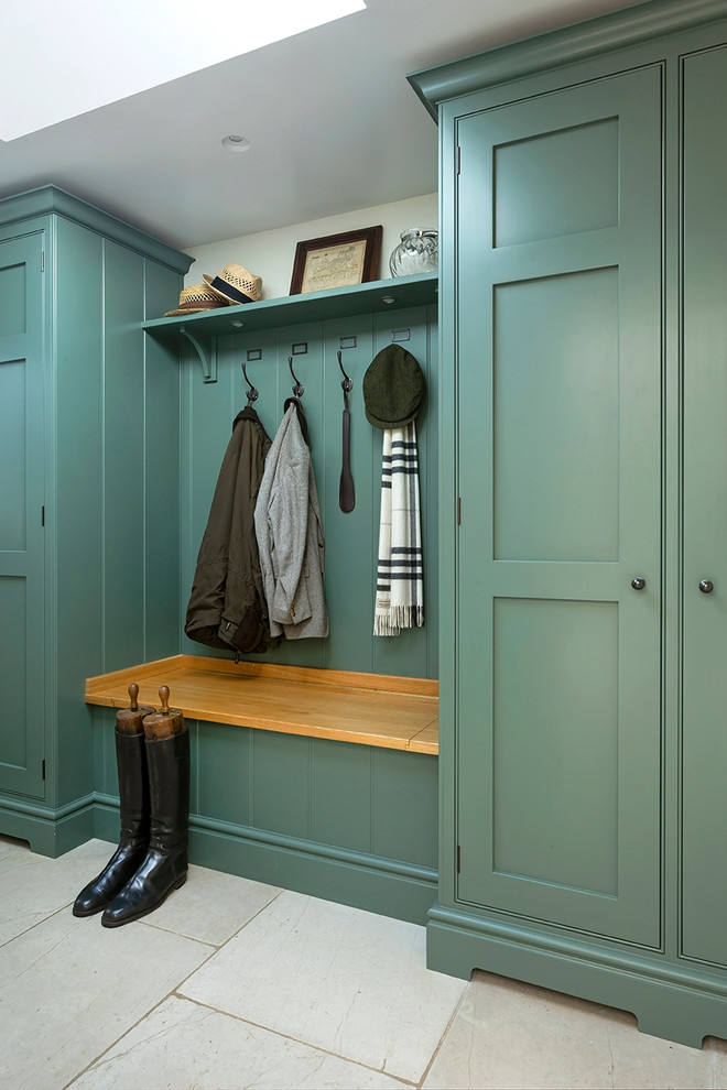 Photo of a classic cloakroom in Surrey with green cabinets.