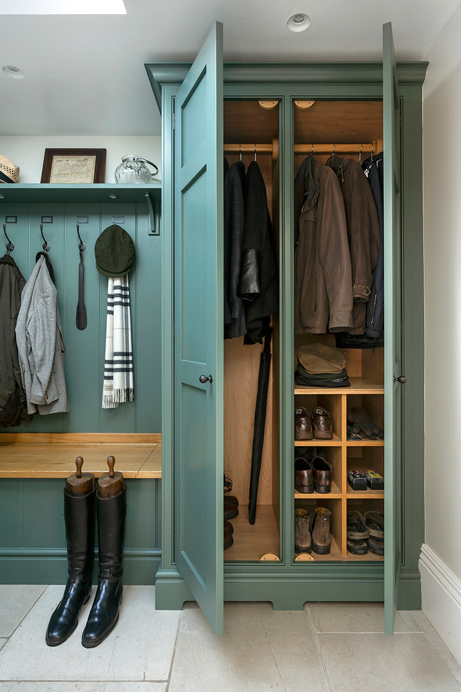 Classic cloakroom in Surrey with green cabinets.