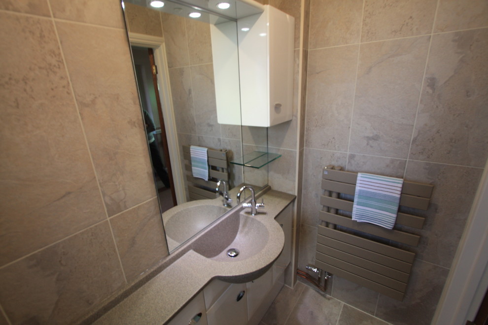 Inspiration for a modern cloakroom in Other with an integrated sink, white cabinets, solid surface worktops, beige tiles, ceramic tiles, beige walls and ceramic flooring.
