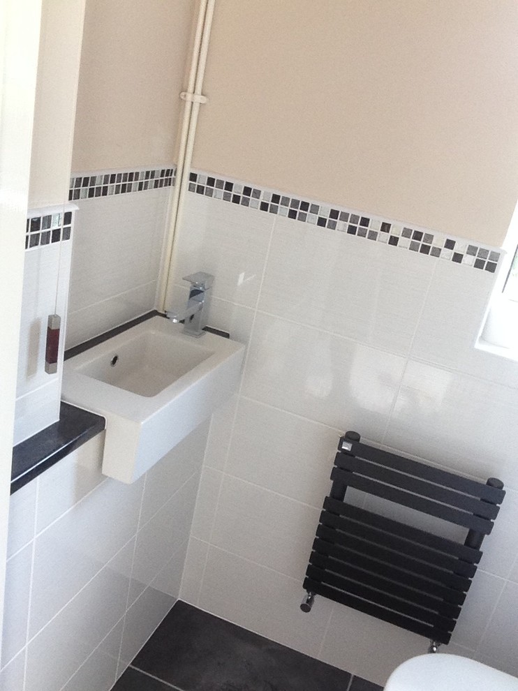 Inspiration for a small modern cloakroom in West Midlands with an integrated sink, white tiles, ceramic tiles and beige walls.