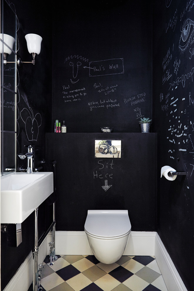 Photo of a small contemporary cloakroom in London with a wall mounted toilet, black walls, ceramic flooring and a wall-mounted sink.