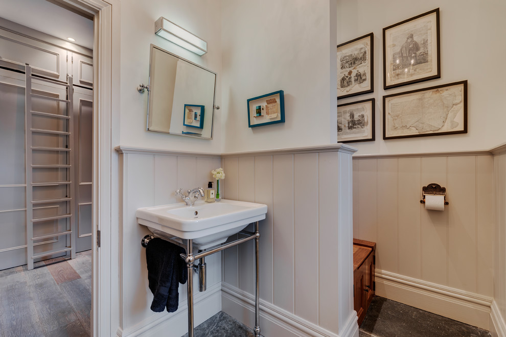 Example of a small cottage slate floor and gray floor powder room design in Devon with beaded inset cabinets, gray cabinets, a wall-mount toilet, gray walls and a pedestal sink