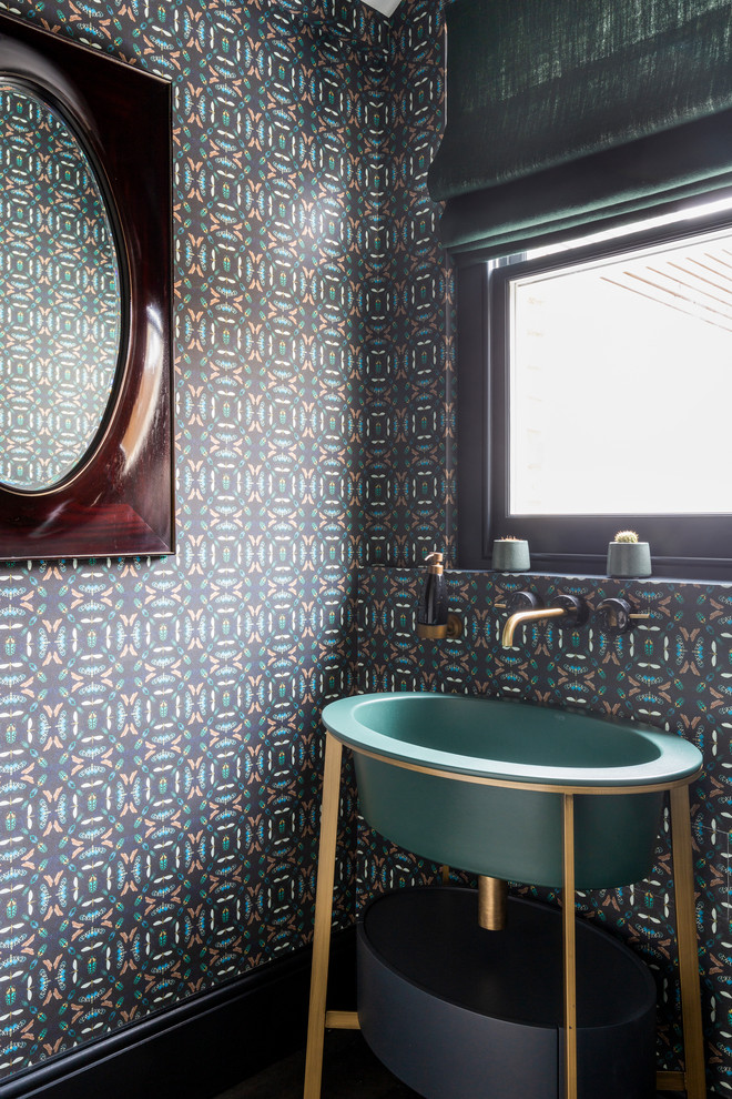This is an example of a contemporary cloakroom in London with multi-coloured walls and a console sink.