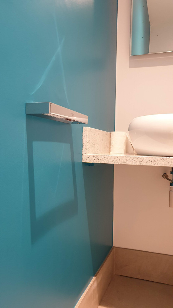 Photo of a small traditional cloakroom in London with open cabinets, white cabinets, a one-piece toilet, green walls, porcelain flooring, a built-in sink, granite worktops, grey floors, grey worktops and a built in vanity unit.