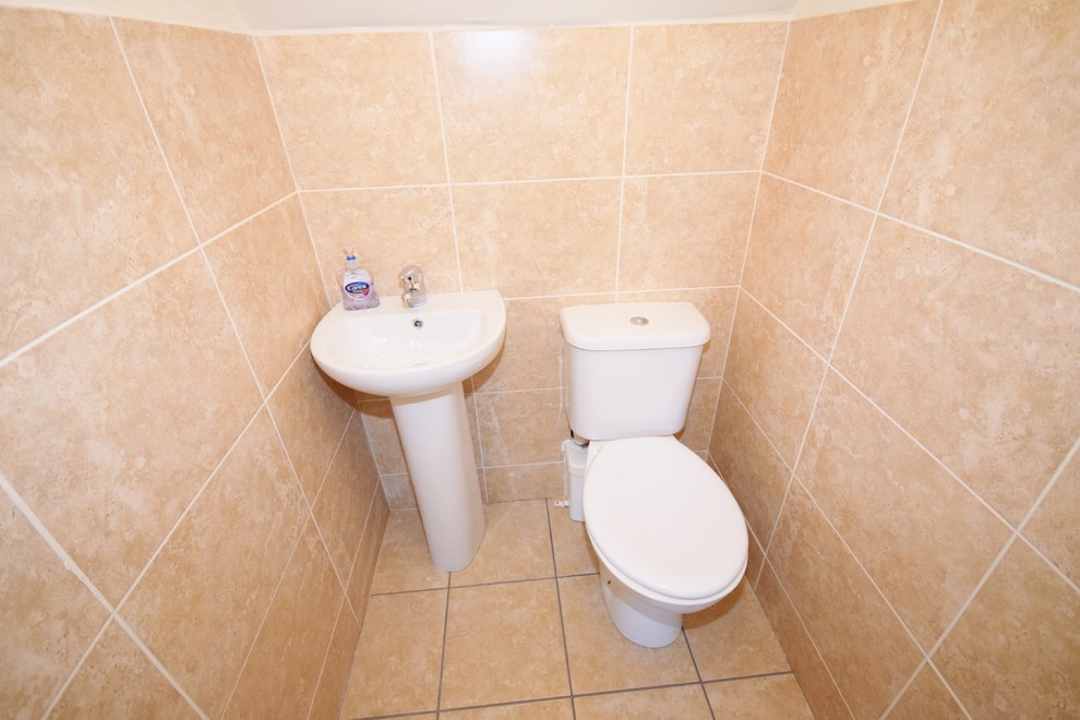 Photo of a small classic cloakroom in Other with beige tiles and ceramic tiles.