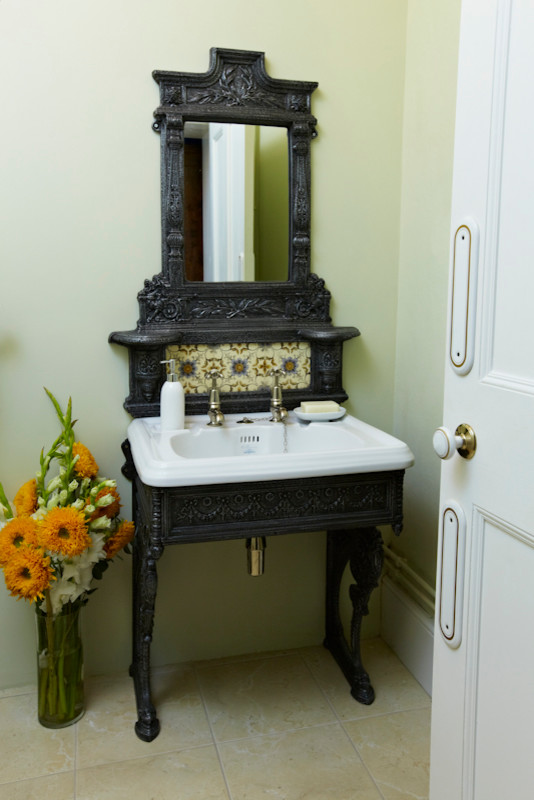Inspiration for a small traditional cloakroom in Other with a pedestal sink, green walls and travertine flooring.