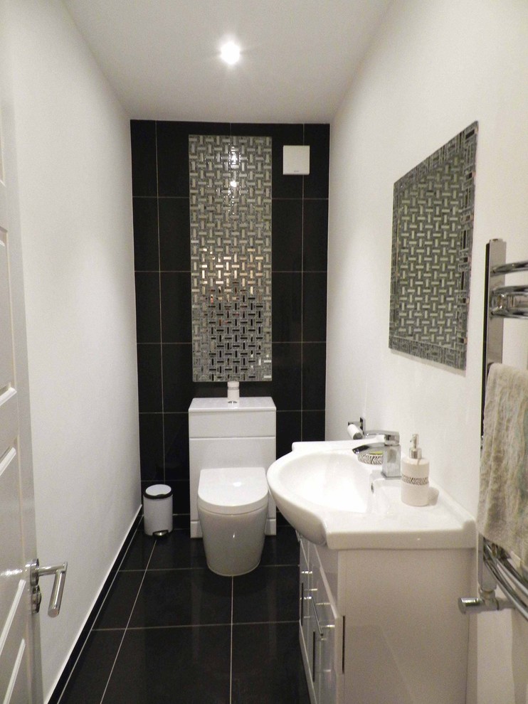 Medium sized contemporary cloakroom in London with white cabinets, white walls and porcelain flooring.