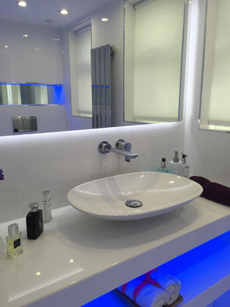Mittelgroße Moderne Gästetoilette mit Sockelwaschbecken, Quarzit-Waschtisch, Wandtoilette, weißen Fliesen, Keramikfliesen, weißer Wandfarbe und Porzellan-Bodenfliesen in London