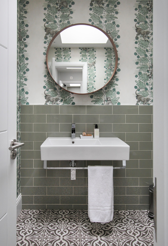 Design ideas for a medium sized contemporary cloakroom in London with green tiles, metro tiles and porcelain flooring.
