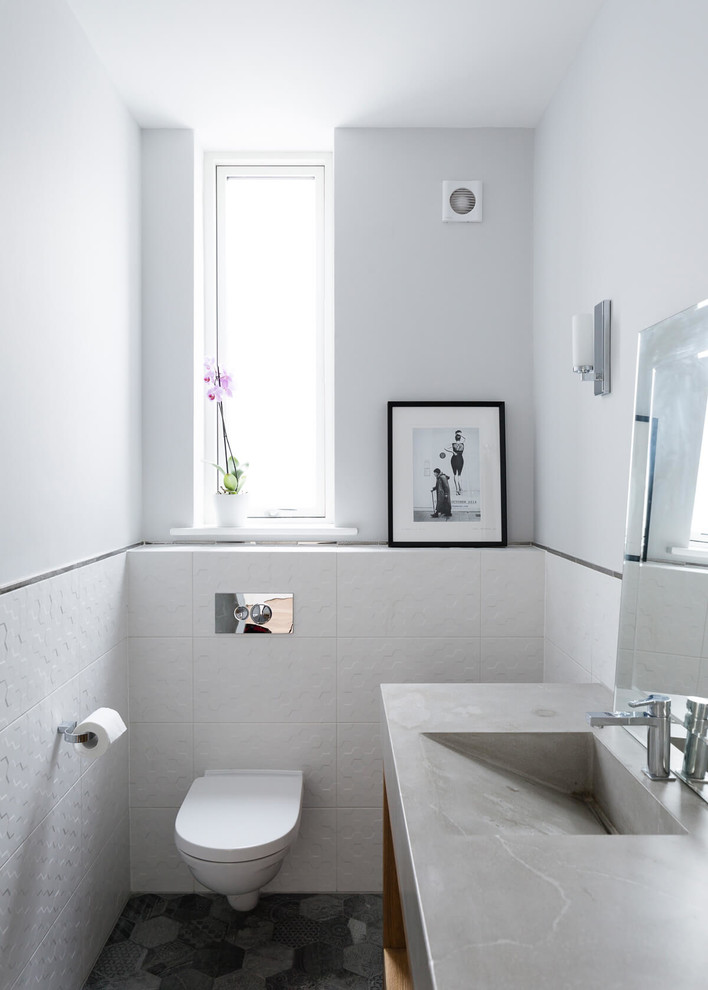 Small trendy black floor powder room photo in Other with a wall-mount toilet and yellow walls