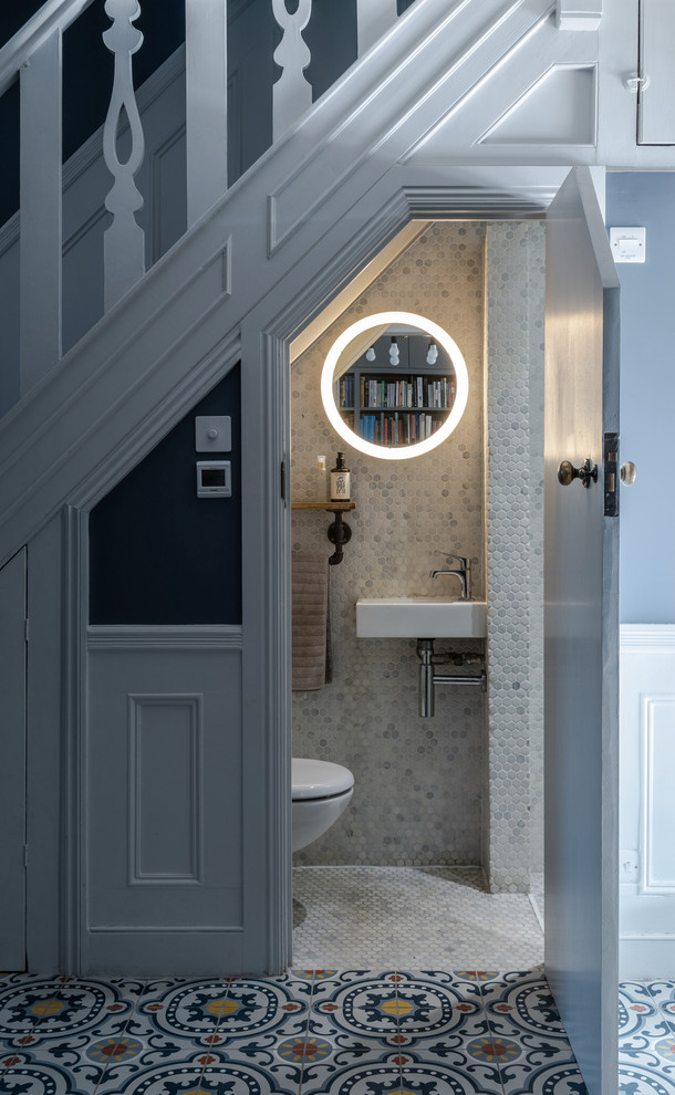 На фото: туалет в стиле неоклассика (современная классика) с белой плиткой, плиткой мозаикой, полом из мозаичной плитки, подвесной раковиной и белым полом с