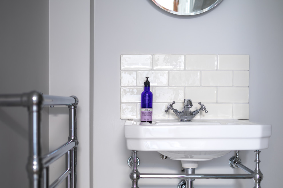 Inspiration for a small contemporary cloakroom in Other with freestanding cabinets, white cabinets, a two-piece toilet, white tiles, ceramic tiles, grey walls, porcelain flooring, a wall-mounted sink, wooden worktops, multi-coloured floors and white worktops.
