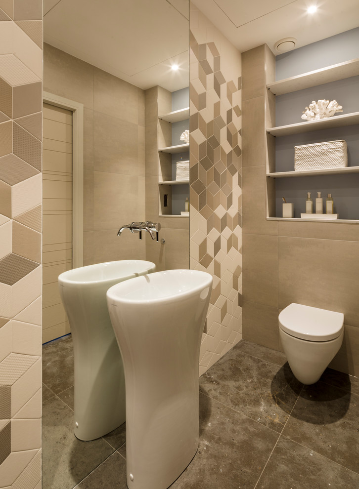 Inspiration for a medium sized contemporary cloakroom in Hertfordshire with an integrated sink, a wall mounted toilet, beige walls, ceramic flooring, beige tiles and light wood cabinets.