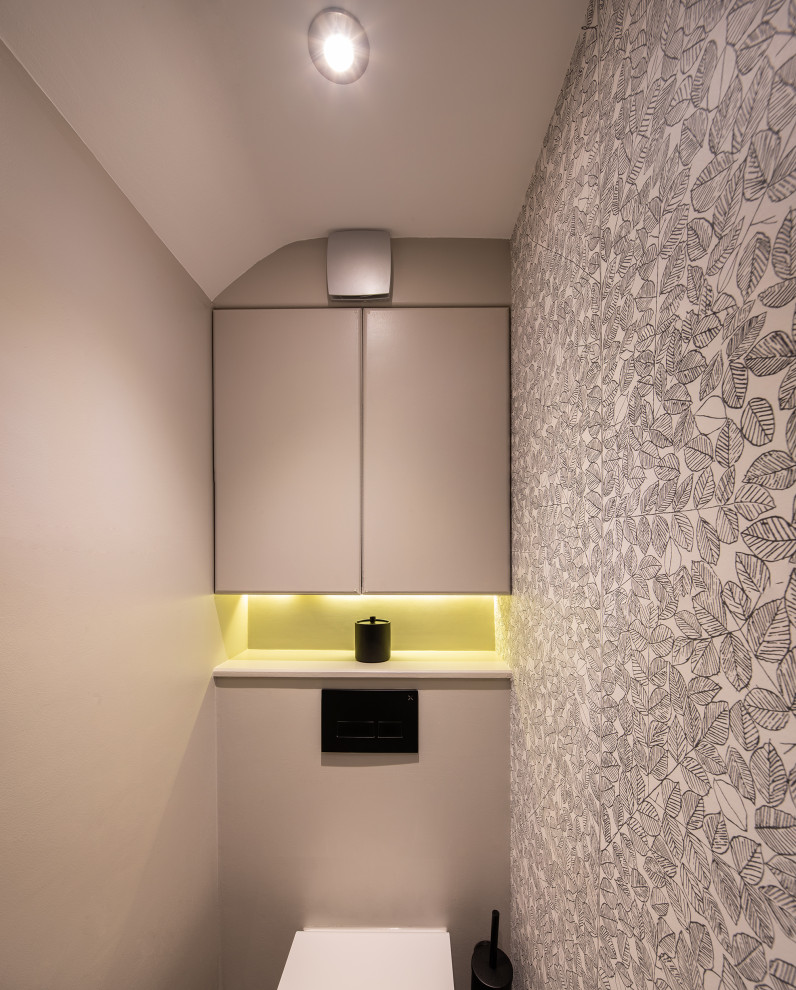 Photo of a medium sized contemporary cloakroom in London.