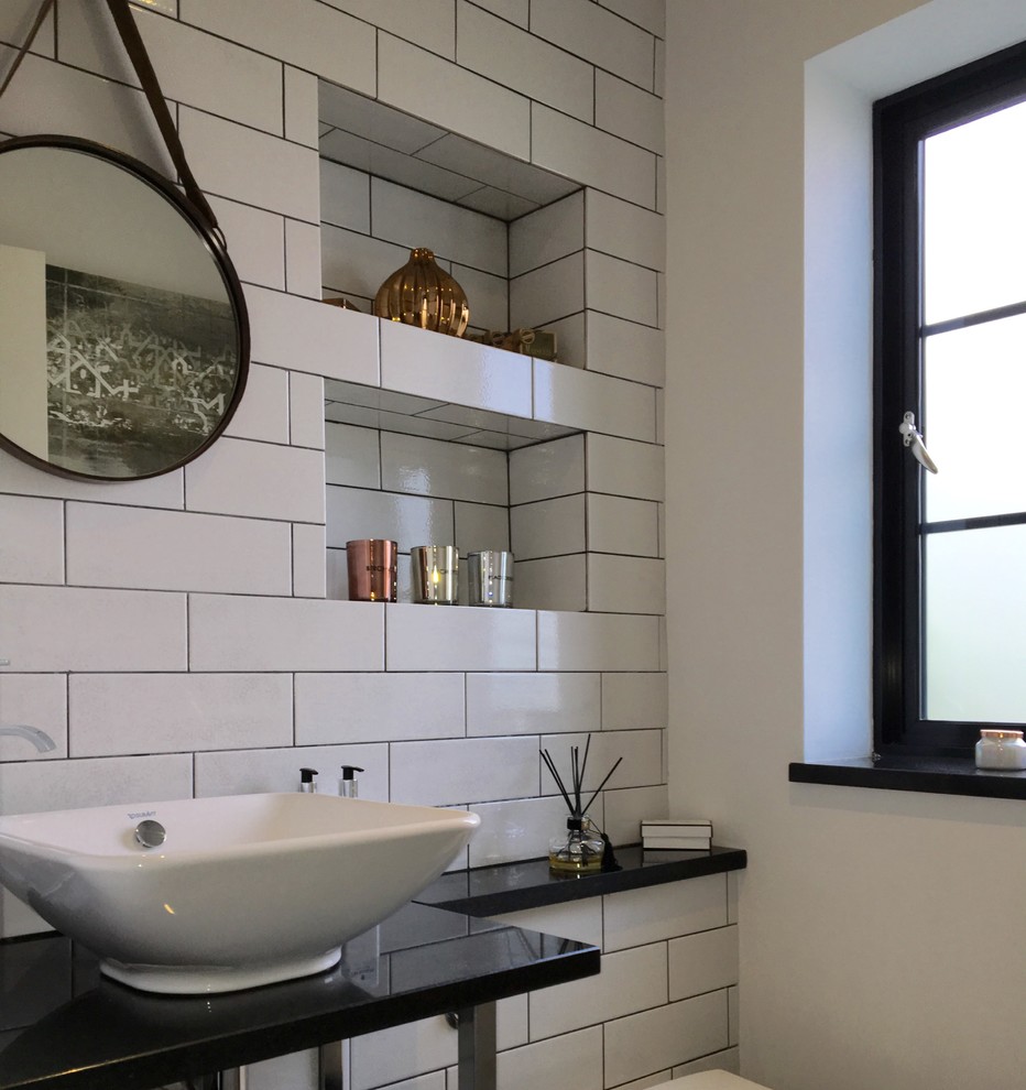 Example of a small urban white tile and subway tile powder room design in Surrey with a one-piece toilet, white walls, granite countertops and a vessel sink