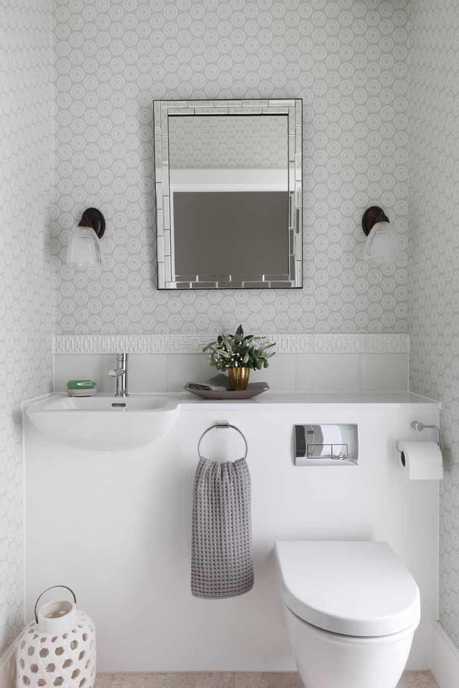 Small transitional powder room photo in London with a wall-mount sink, gray walls and a wall-mount toilet