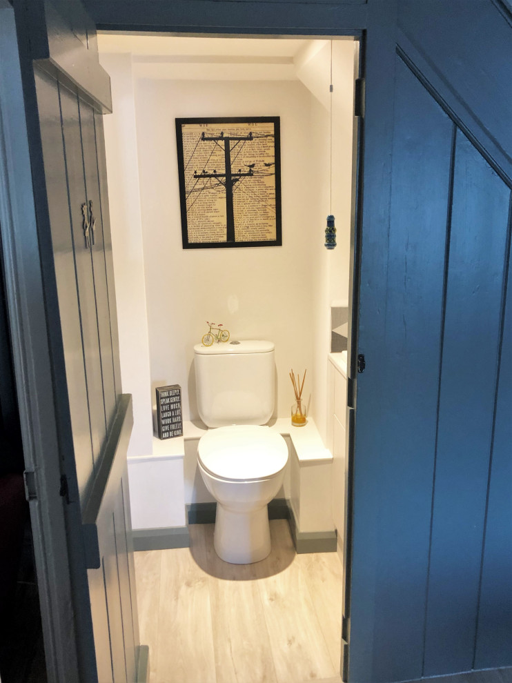 ドーセットにある小さなラスティックスタイルのおしゃれなトイレ・洗面所 (分離型トイレ、モノトーンのタイル、セメントタイル、白い壁、横長型シンク) の写真