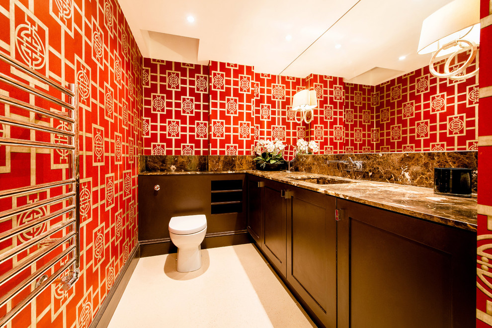 На фото: туалет в восточном стиле с фасадами в стиле шейкер, темными деревянными фасадами, унитазом-моноблоком, красными стенами и врезной раковиной