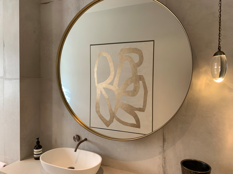Example of a mid-sized trendy white tile and ceramic tile ceramic tile and gray floor powder room design in Cheshire with a wall-mount toilet, white walls, tile countertops and white countertops