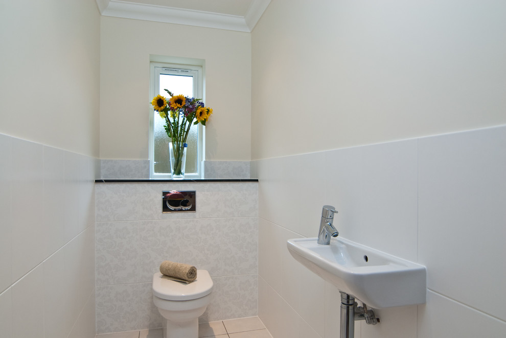 Small trendy white tile and ceramic tile powder room photo in Other with a two-piece toilet and a wall-mount sink
