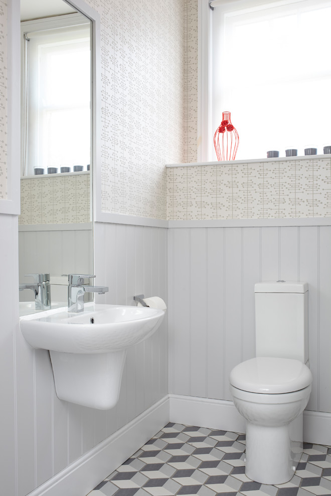 Idee per un piccolo bagno di servizio design con WC monopezzo, pareti grigie, lavabo sospeso e pavimento multicolore