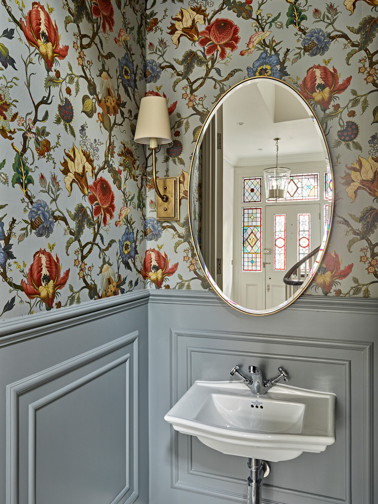 Mid-sized elegant powder room photo in London with a wall-mount sink and multicolored walls