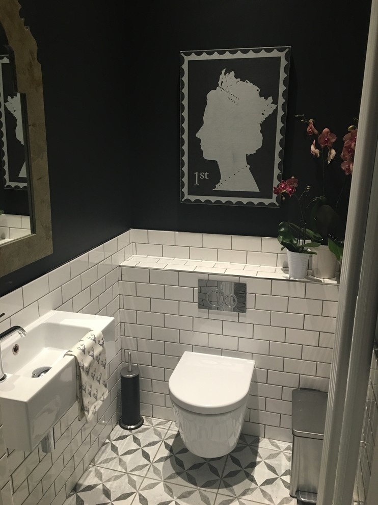 Example of a small ornate white tile and subway tile ceramic tile and multicolored floor powder room design in London with black walls, a wall-mount toilet and a wall-mount sink