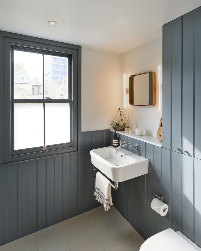 Design ideas for a traditional cloakroom in London with grey walls, a wall-mounted sink and grey floors.